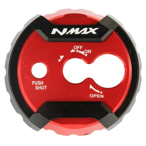 The Nitex CNC Ignition Key Cover is an aftermarket accessory specifically designed for Yamaha NMAX motorcycles. It is a cover that fits around the ignition key area, providing added protection and enhancing the overall aesthetic of the bike.